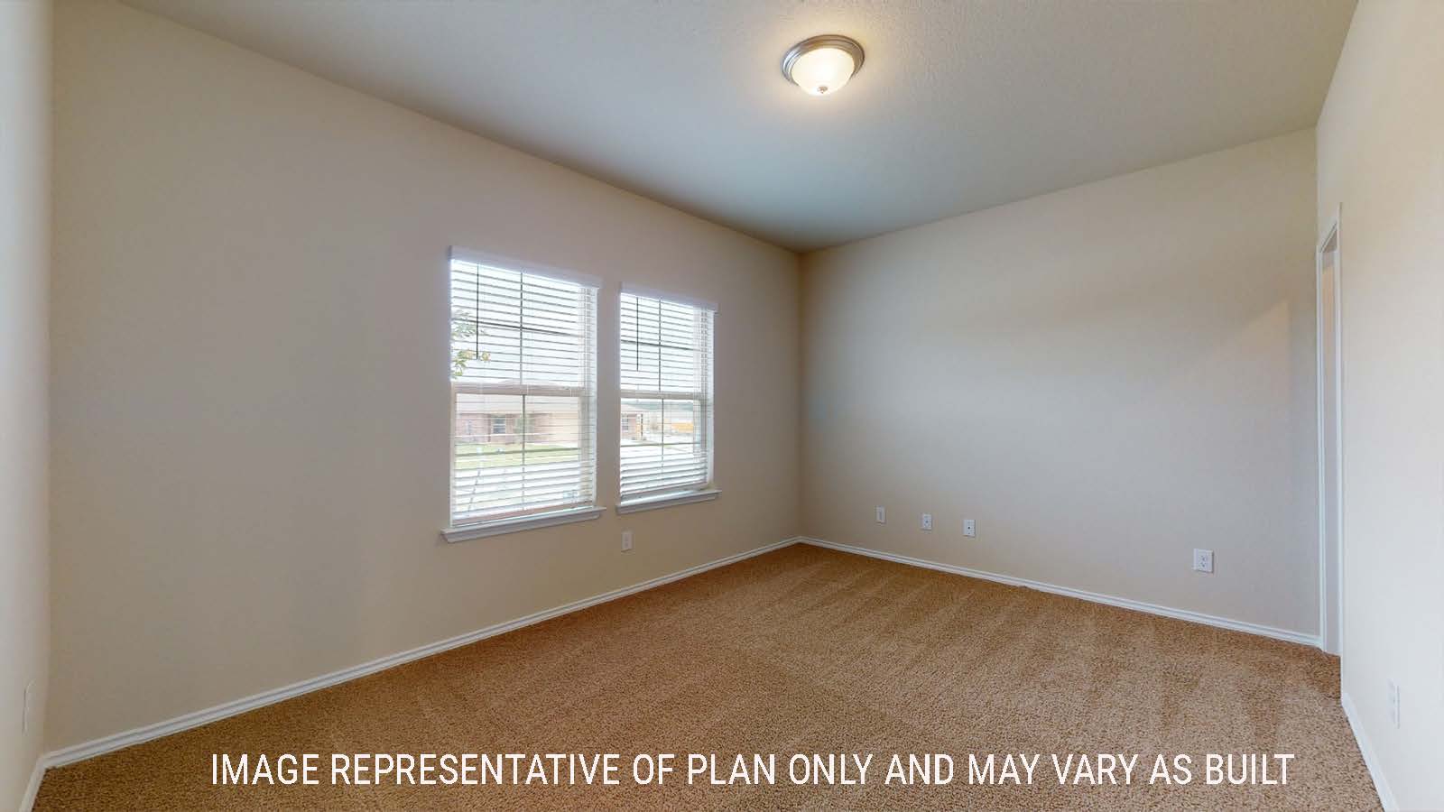 Perry study with carpeted flooring and windows for natural lighting.