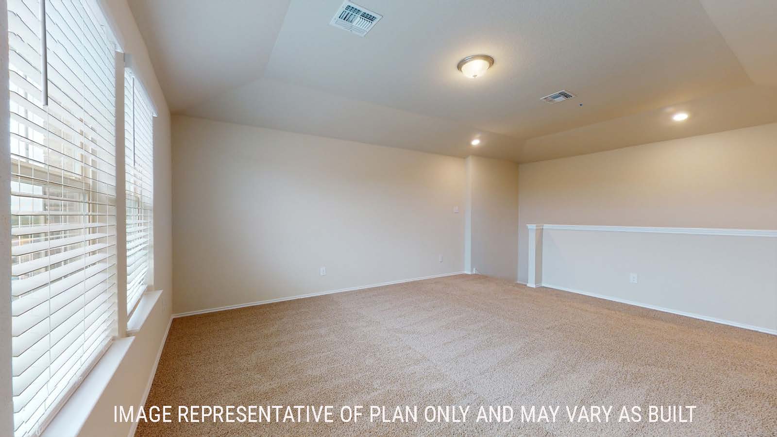 Perry game room with carpted flooring and windows for natural lighting.