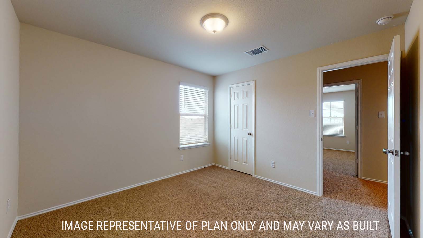 Perry secondary bedroom with carpted flooring and window for natural lighting.
