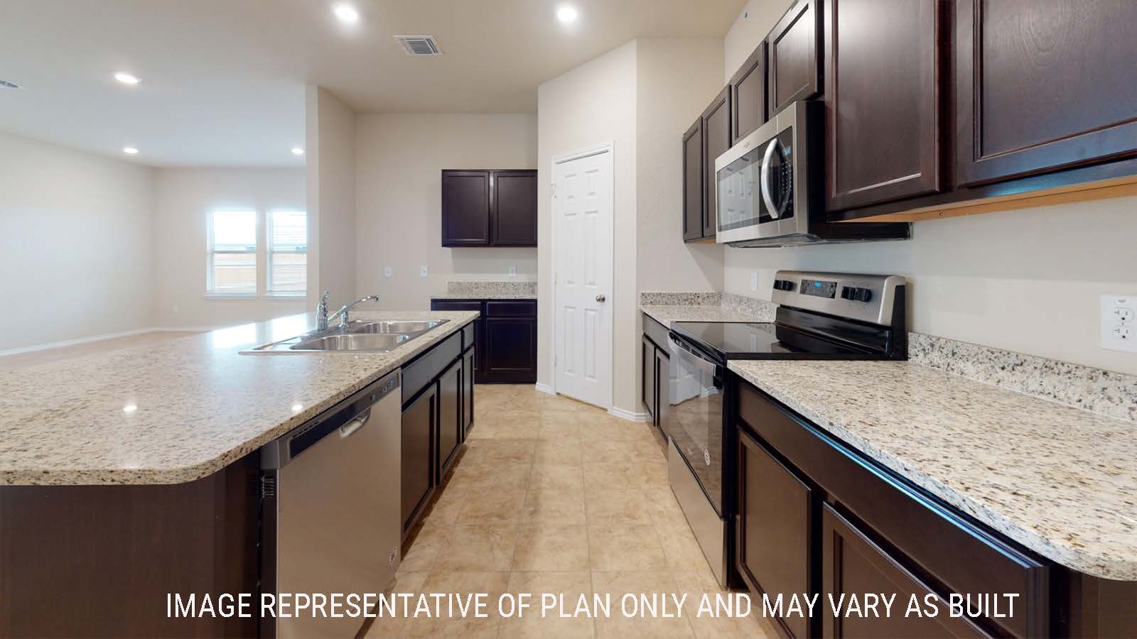 Perry kitchen with kitchen isand and dark cabinets and granite countertops.