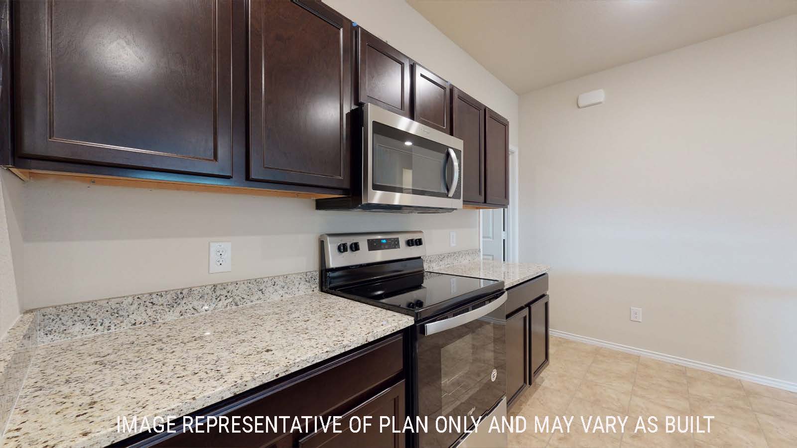 Perry kitchen with dark cabinets and granite countertops with view of utility room.