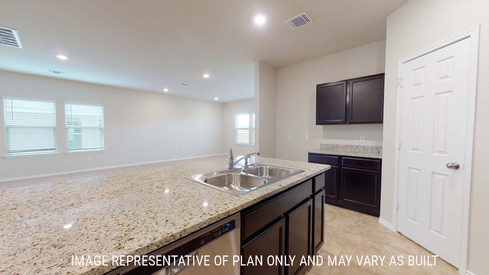 Perry kitchen with kitchen island with granite countertops and view of open concept living room.