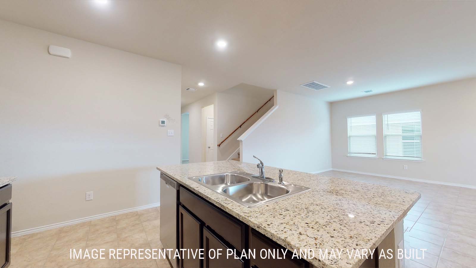 Perry kitchen with kitchen island with granite countertops and view of open concept dining room.