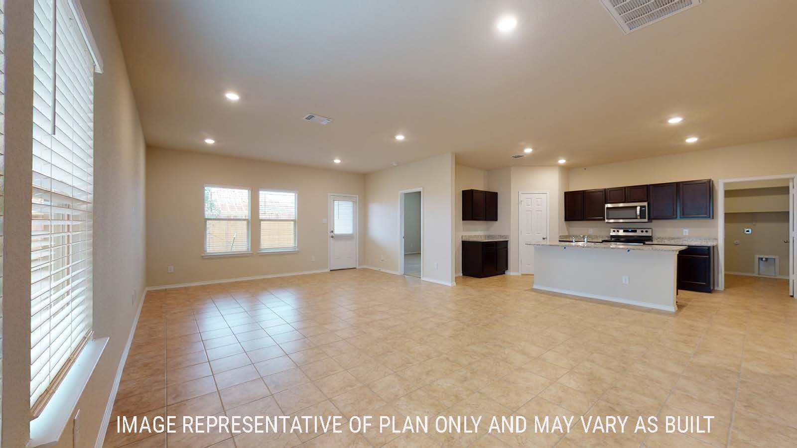 Perry dining room with windows for natural lighting and view of open concept living room and kitchen.