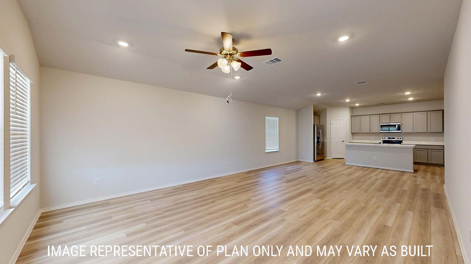 Gaven living room with vinyl plank flooring and view of open concept dining room and kitchen.