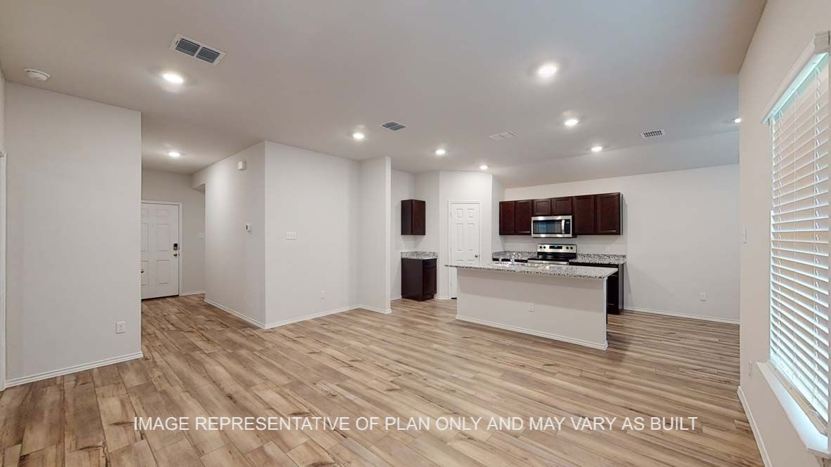Ashburn living room with vinyl plank flooring and view into kitchen.