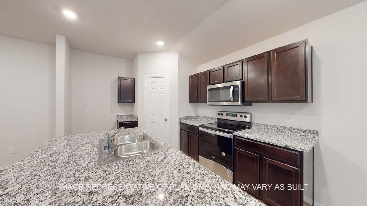 Ashburn kitchen with granite countertops and dark cabinets.