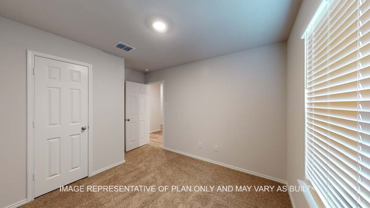 Ashburn secondary bedroom with carpet flooring and window.