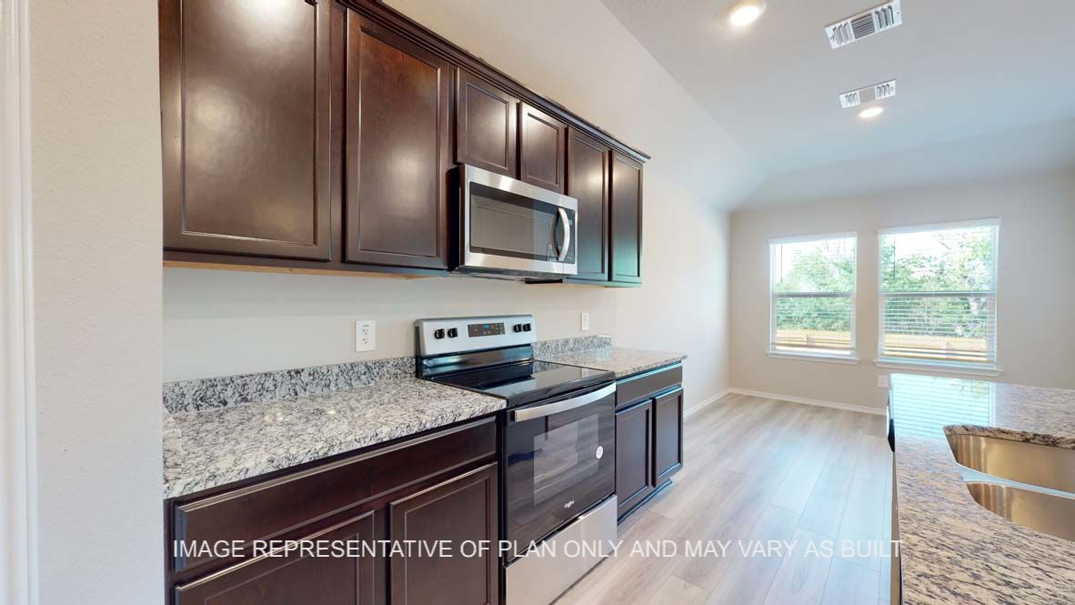 Bellvue kitchen with dark cabinets and granite countertops.