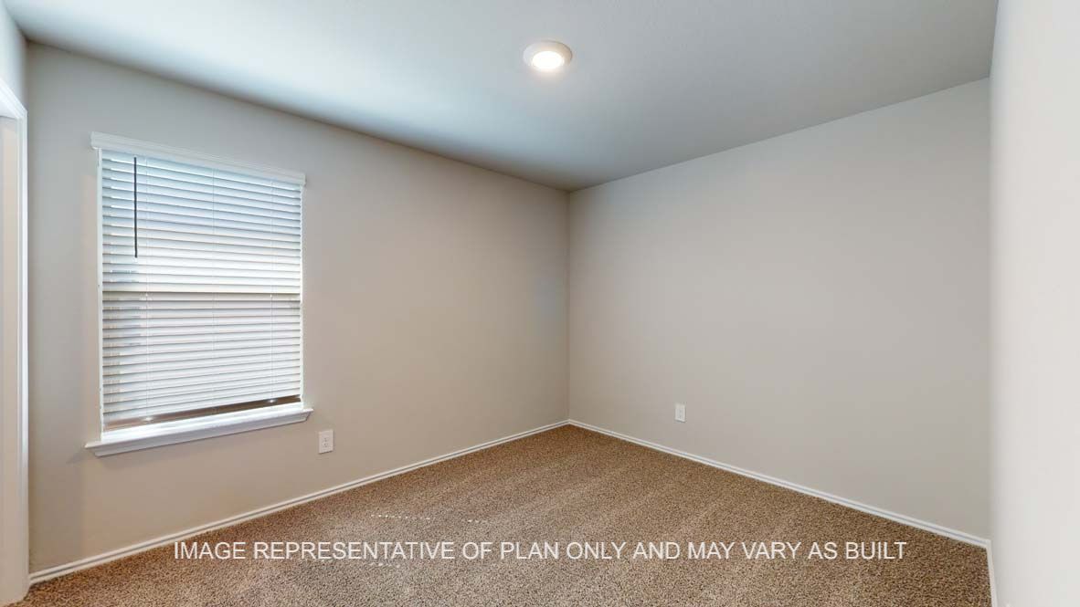 Bellvue secondary bedroom with carpet flooring and window.