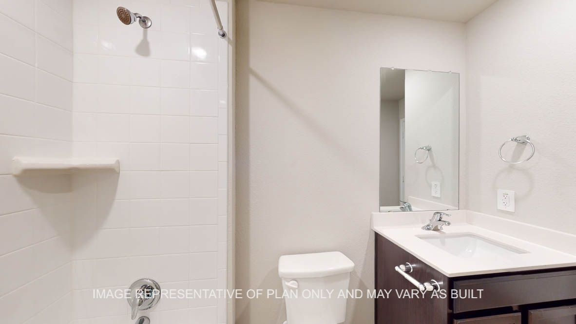 Camden secondary bathroom with dark cabinets and white countertops and vinyl flooring.