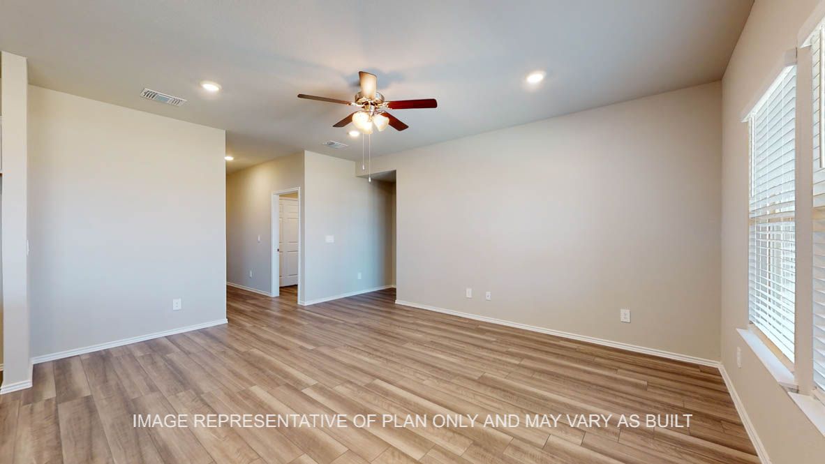 Fargo living room with vinyl plank flooring and view to entry hallway.