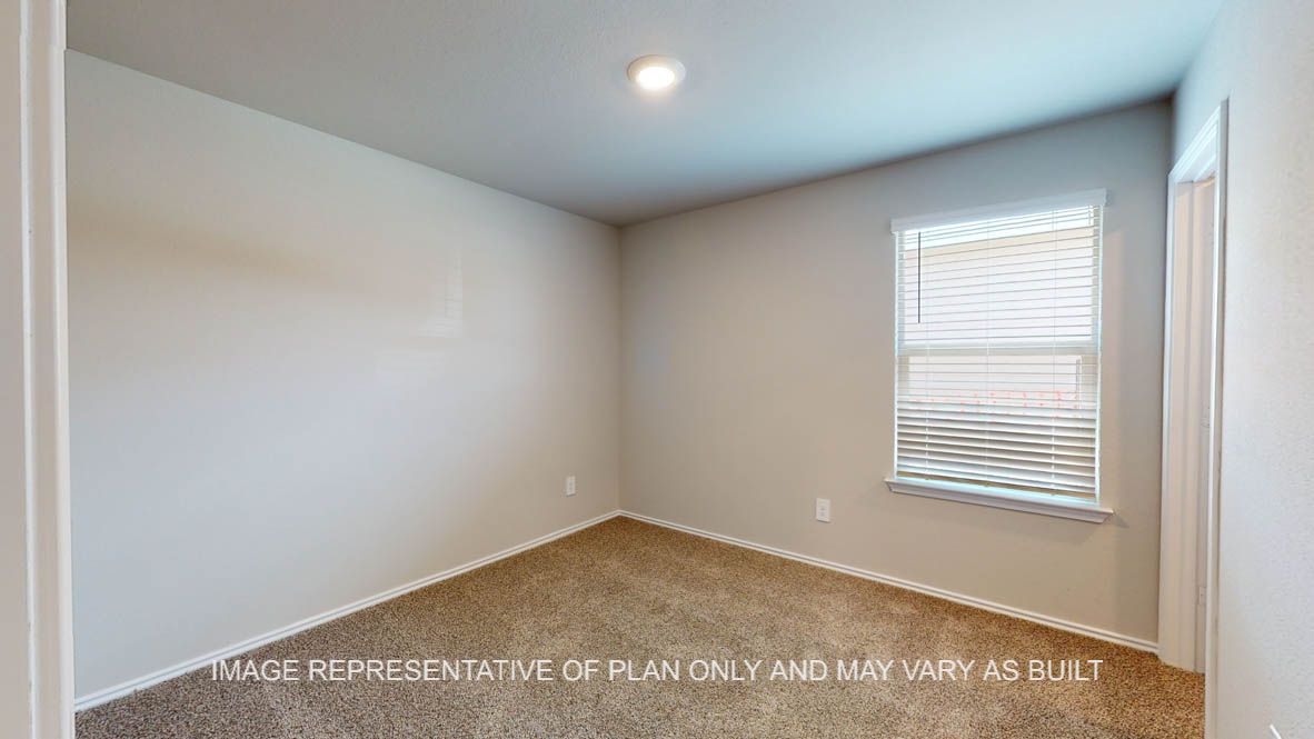 Fargo secondary bedroom with carpet flooring and window.