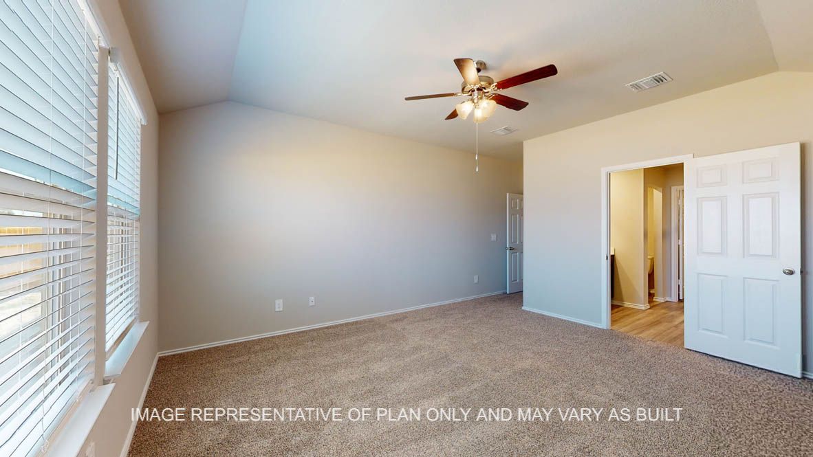 Fargo primary bedroom with view to connecting bathroom.