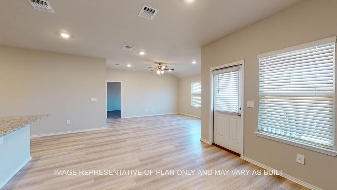 Texas Cali open concept dining room and living room with vinyl plank flooring throughout.