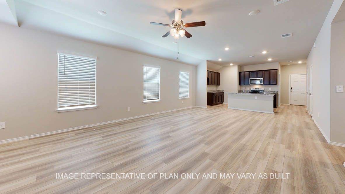 Seabrook living room with vinyl plank flooring with view into kitchen.
