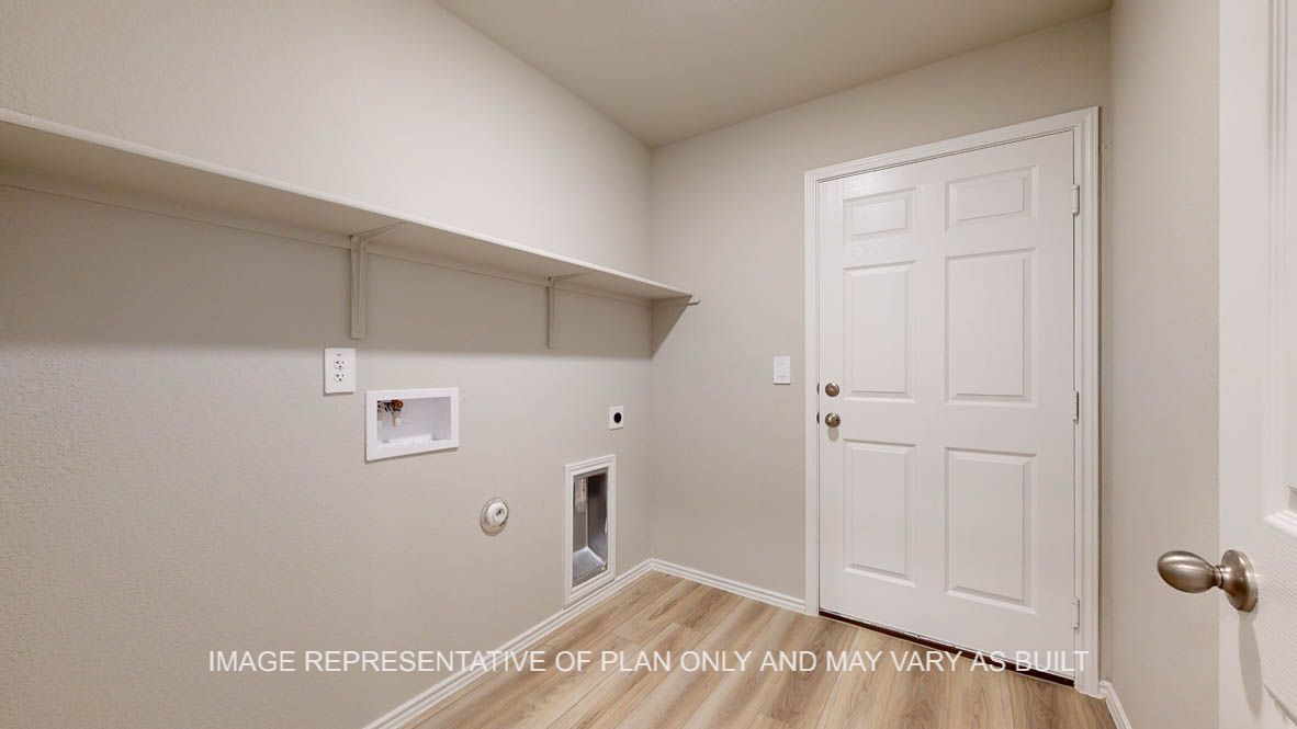 Seabrook utility room with vinyl plank flooring and storage shelf.