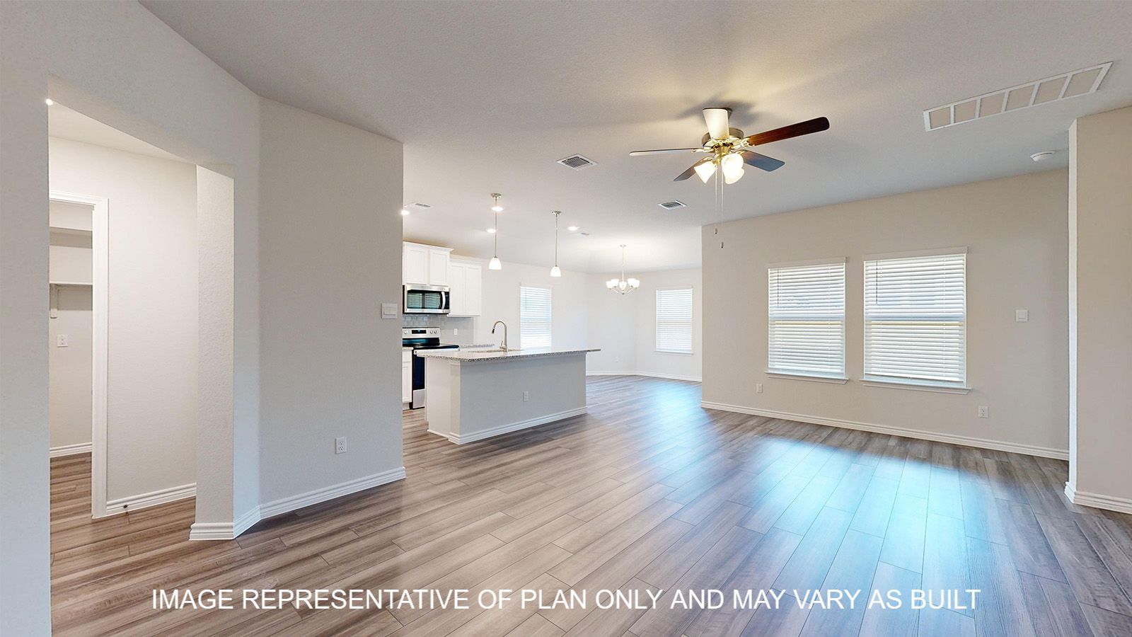 Alpine entry with vinyl plank flooring and view into open concept living and kitchen.
