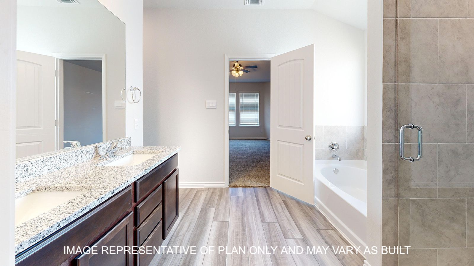 Alpine primary bath with vinyl flooring and dark cabinets.