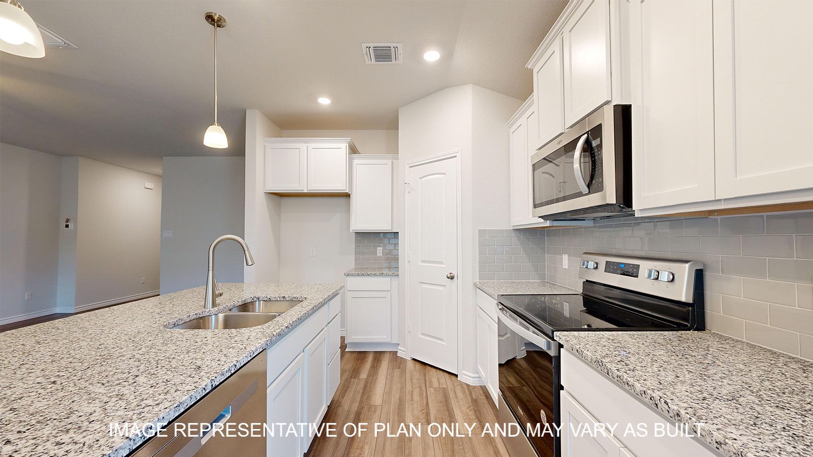 Alpine kitchen with white cabinets and granite countertops and vinyl planks flooring.