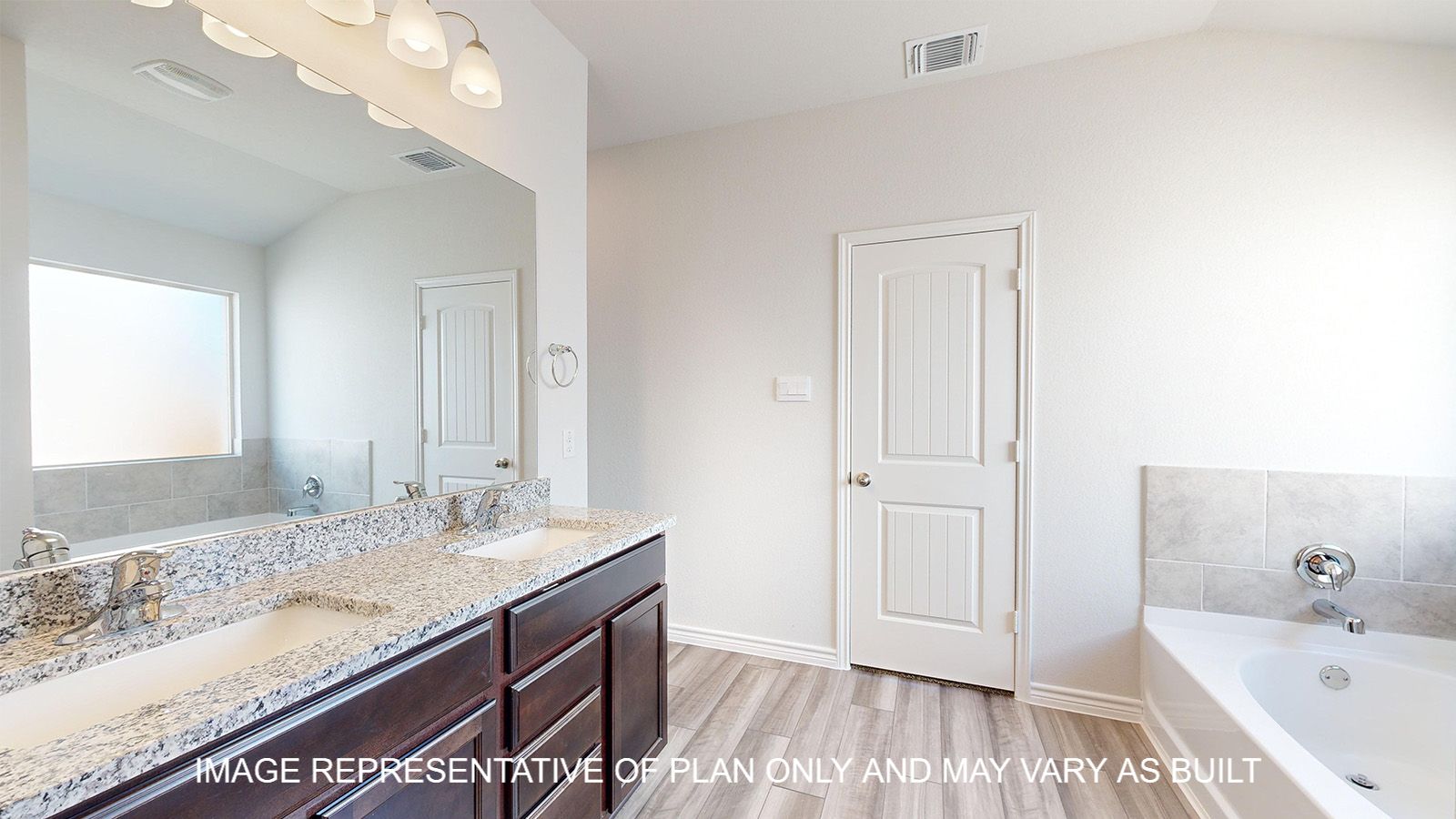 Alpine primary bath with dark cabinets and granite countertops.