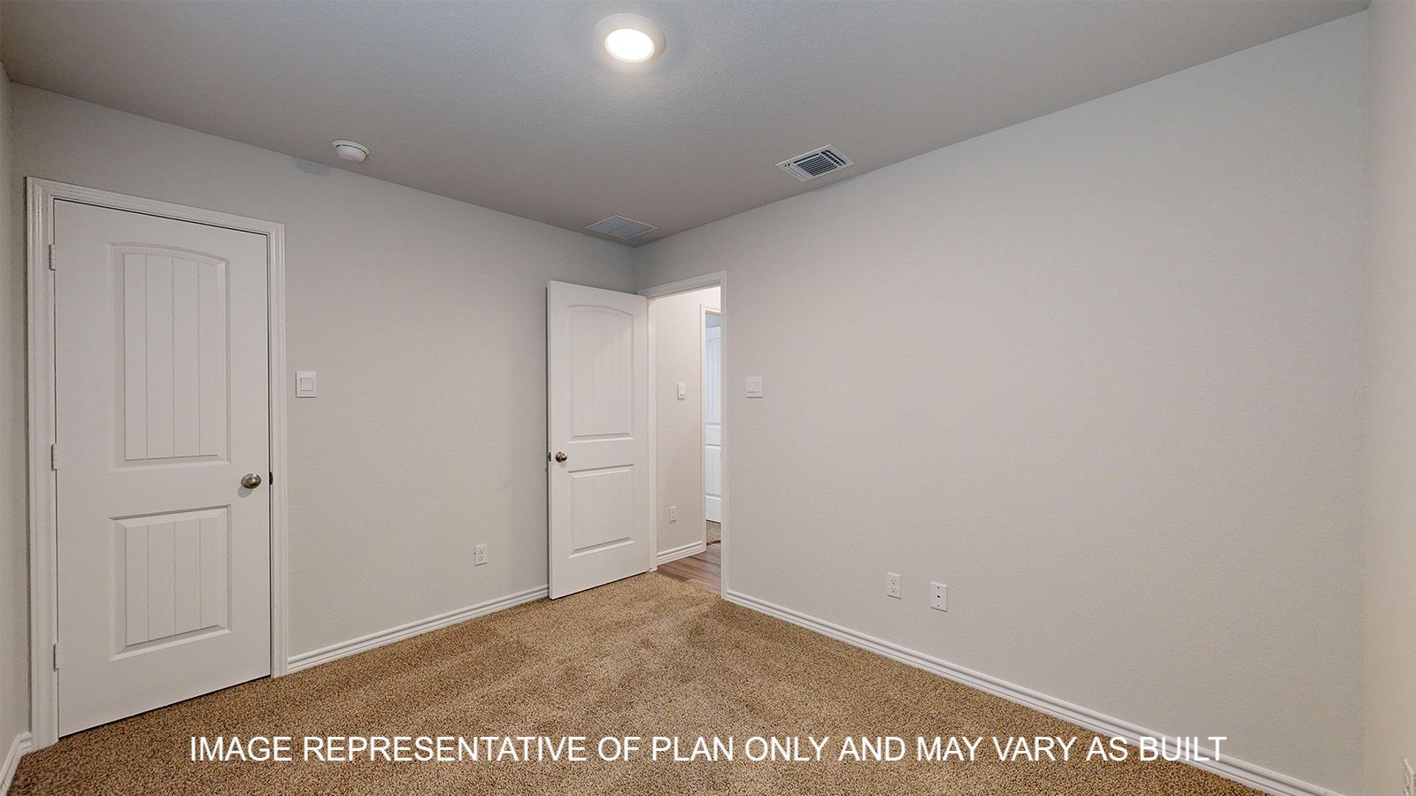 Alpine secondary bedroom with carpet flooring and closet door.