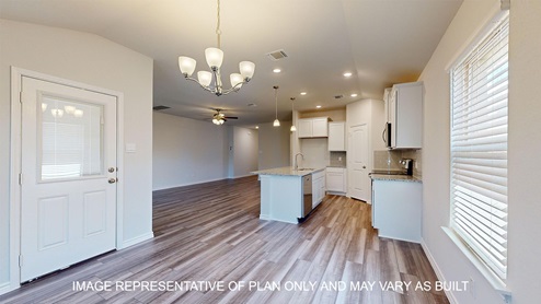 Alpine dining room with view into open concept kitchen and living room and access to back porch.