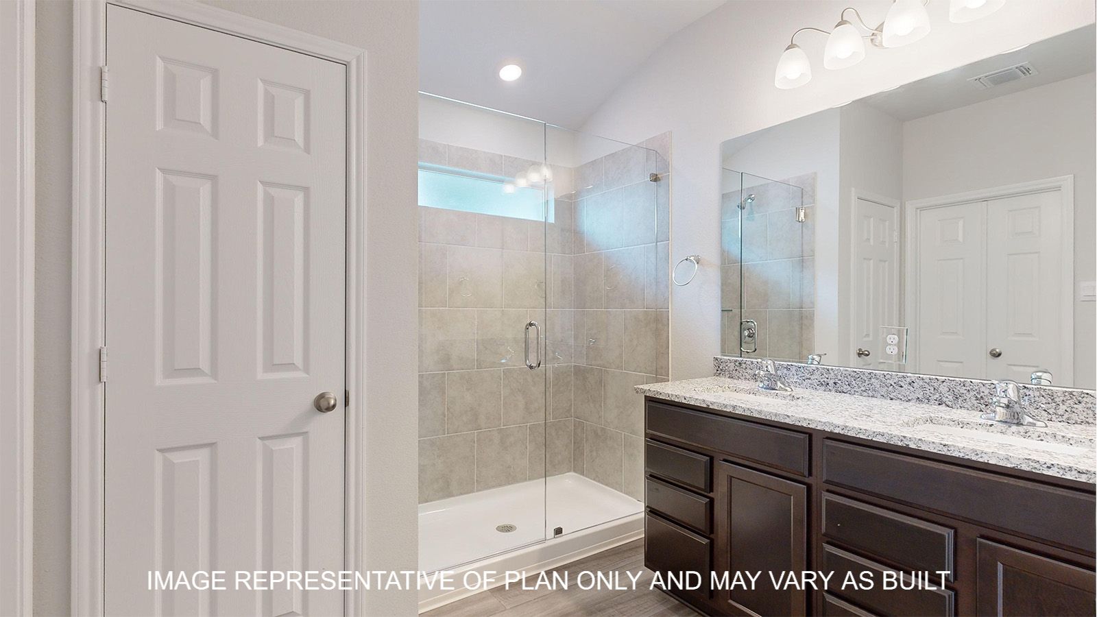 Dakota primary bathroom with walk-in shower with clear glass enclosure and ceramic tile surround.