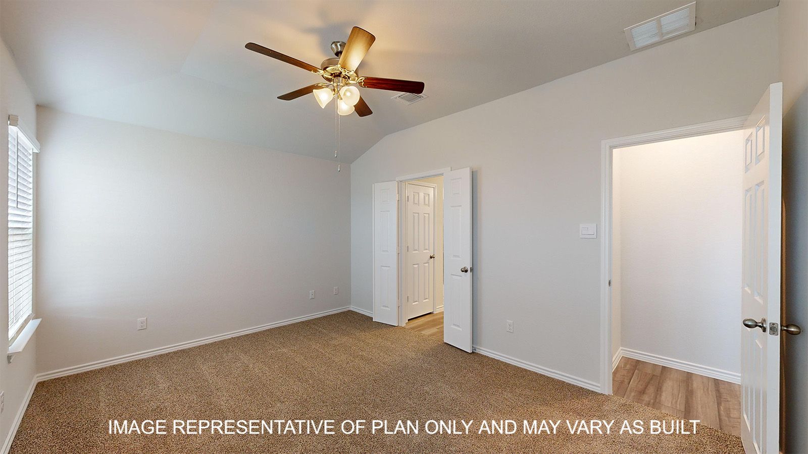 Dakota primary bedroom with carpet flooring and French doors into primary bathroom.