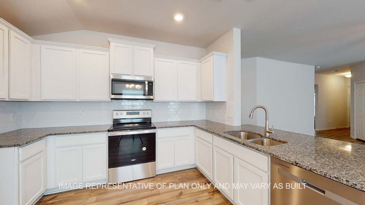 Roosevelt kitchen with white cabinets and granite countertops.