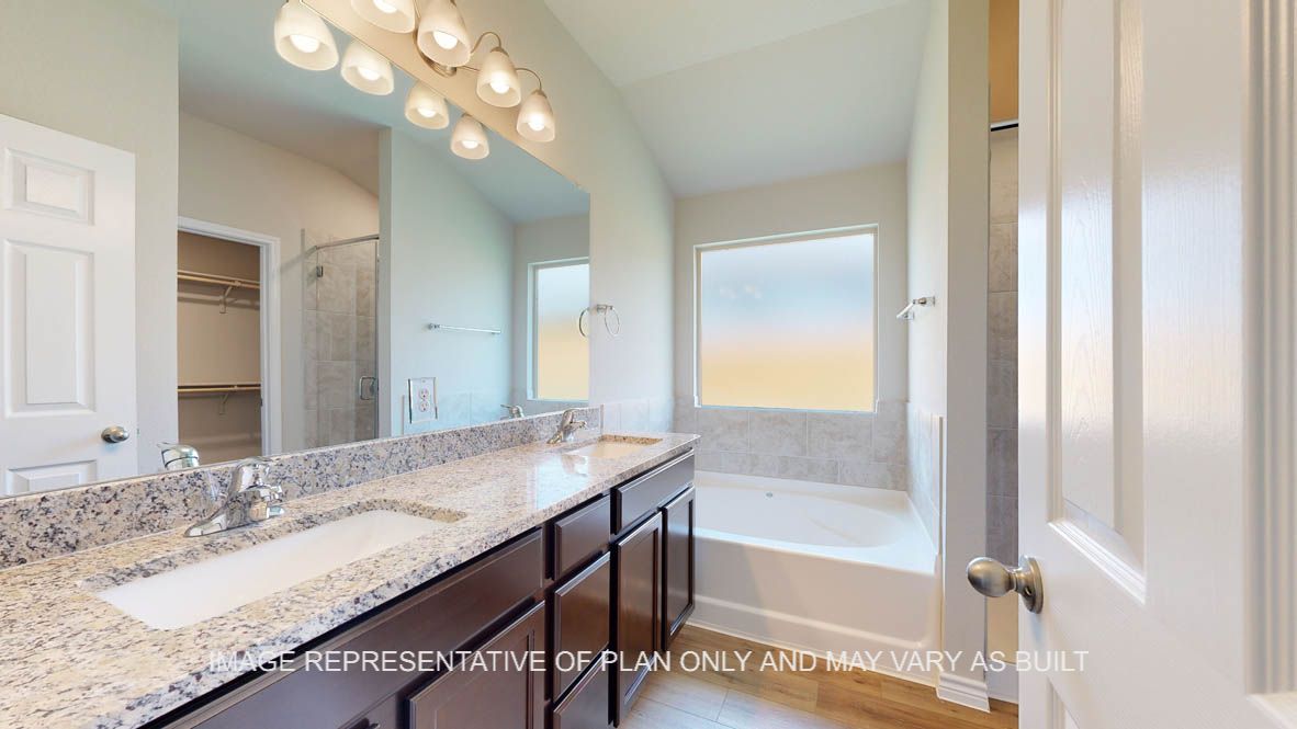 Richmond primary bathroom dual vanities with granite countertops.