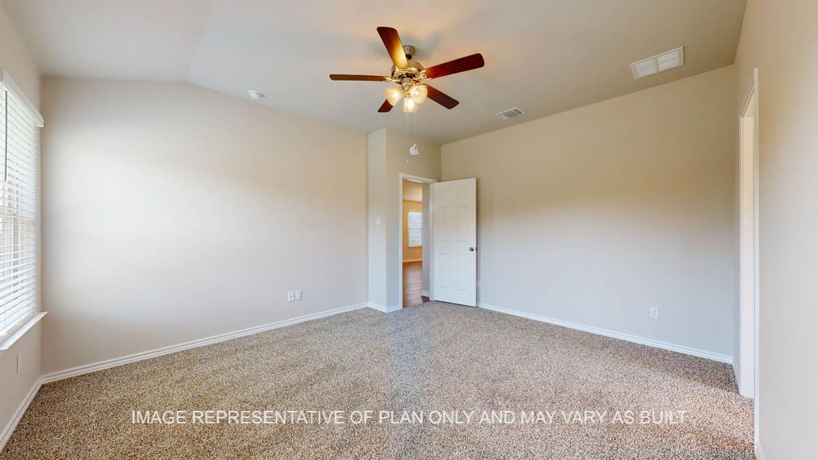 Richmond primary bedroom with carpet flooring and ceiling fan.
