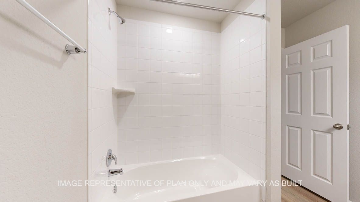 Richmond secondary bathroom with tub and shower combo and white ceramic tile surround.