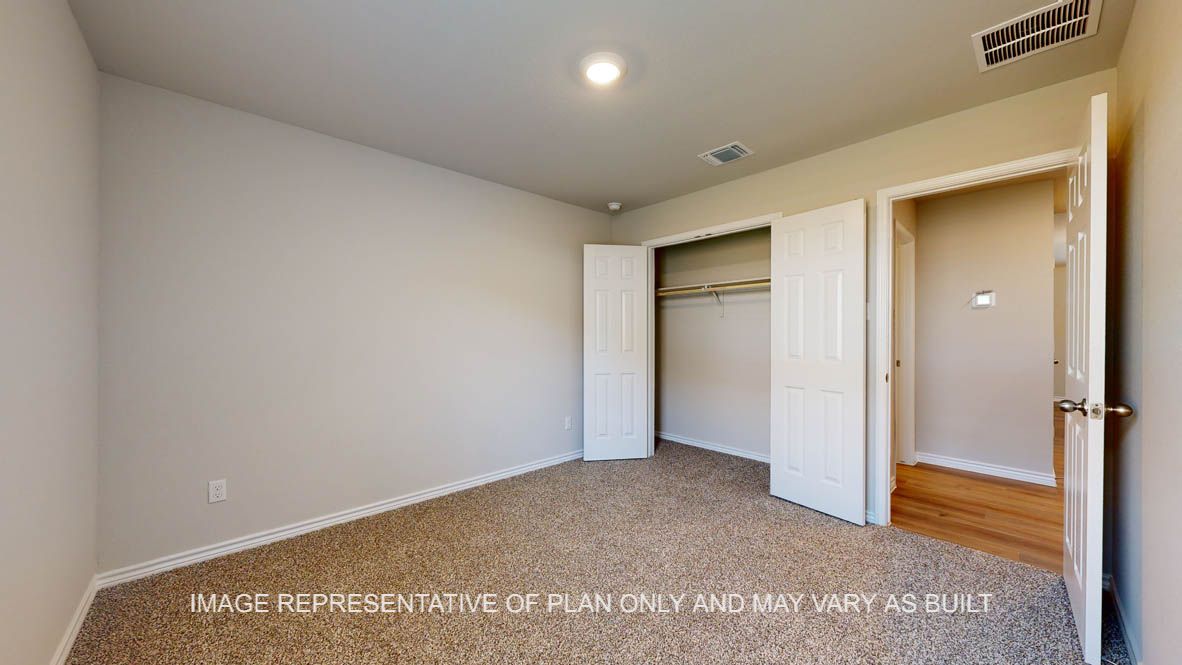 Richmond secondary bedroom with carpet flooring and closet.
