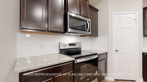 Richmond kitchen with dark cabinets and stainless appliances.