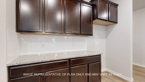 Richmond kitchen with dark cabinets and granite countertops.