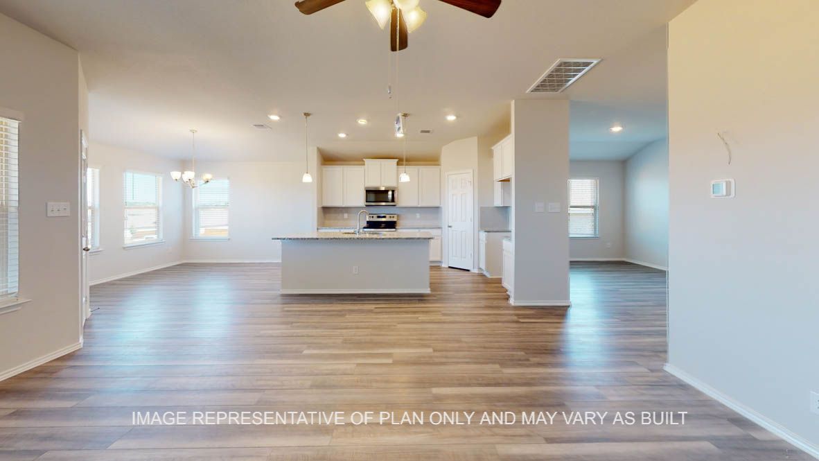 Prescott living room with view into kitchen and vinyl flooring throughout.