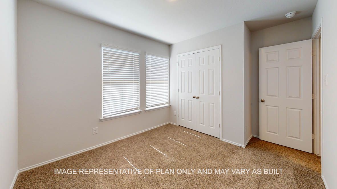 Prescott secondary bedroom with carpet flooring and window.