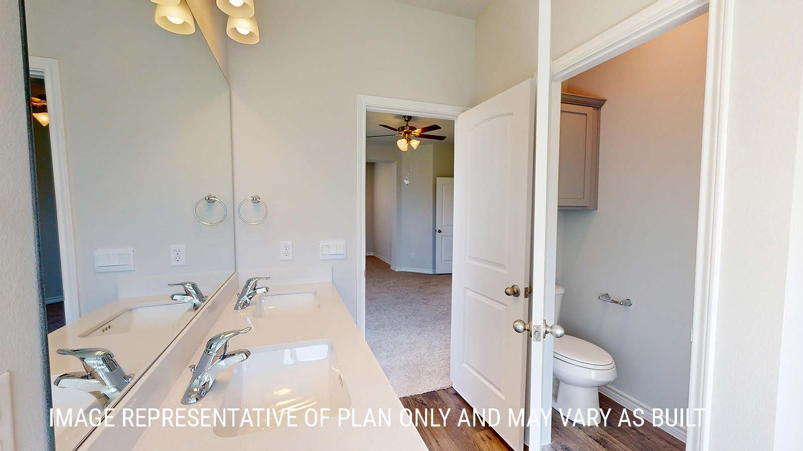 Sonoma primary bathroom with duel vanity sinks and granite countertops and mirror.