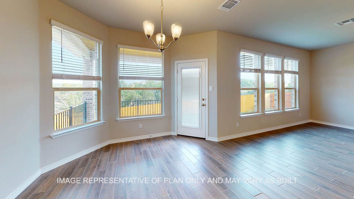 Kiawa breakfast nook with bay windows and light fixture.