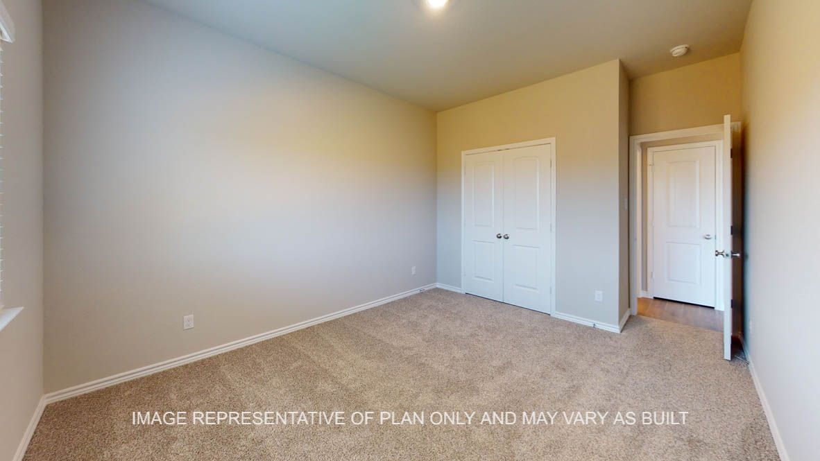 Kiawa secondary bedroom downstairs with carpet flooring.