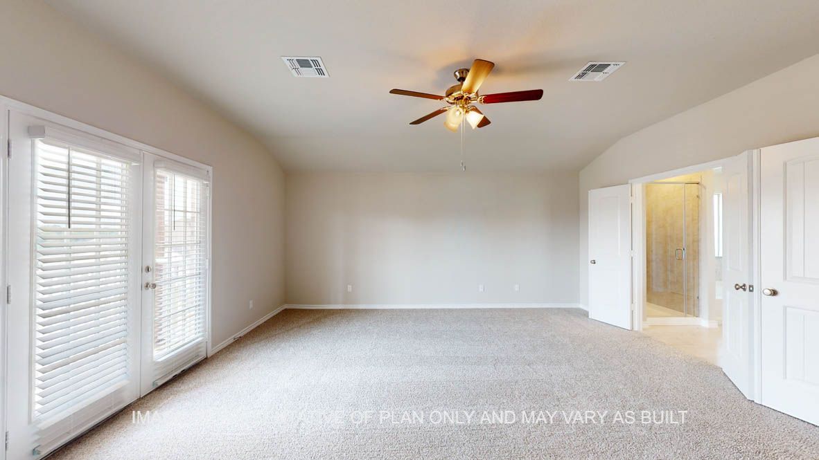 Kiawa bedroom with glass french doors onto patio.