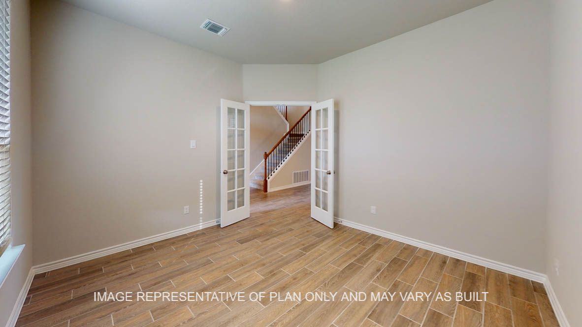 Kiawa study with vinyl plank flooring and glass french doors.