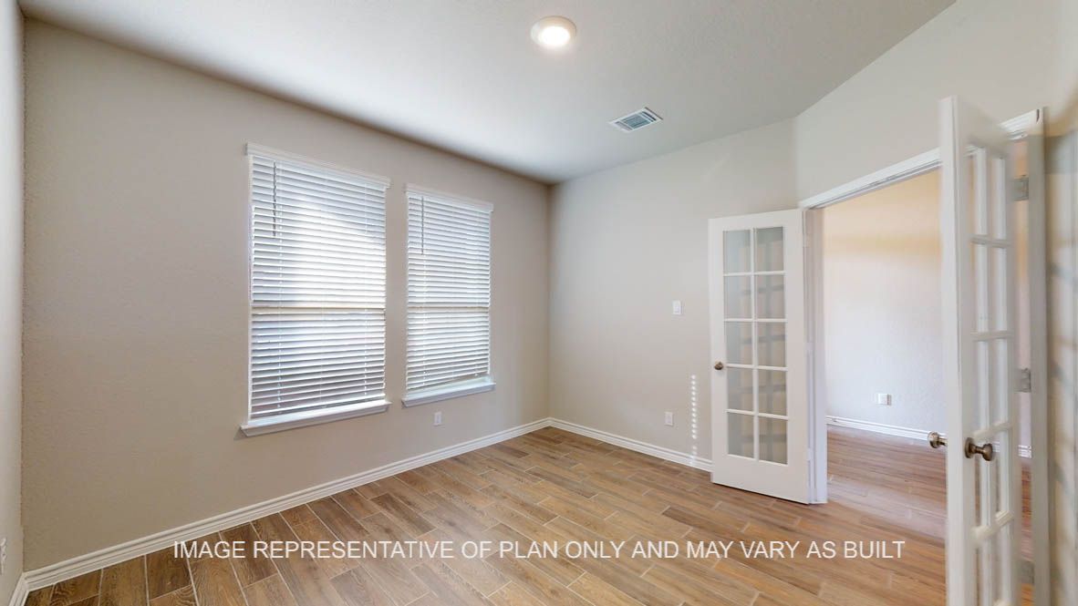 Kiawa study with vinyl plank flooring and glass french doors.