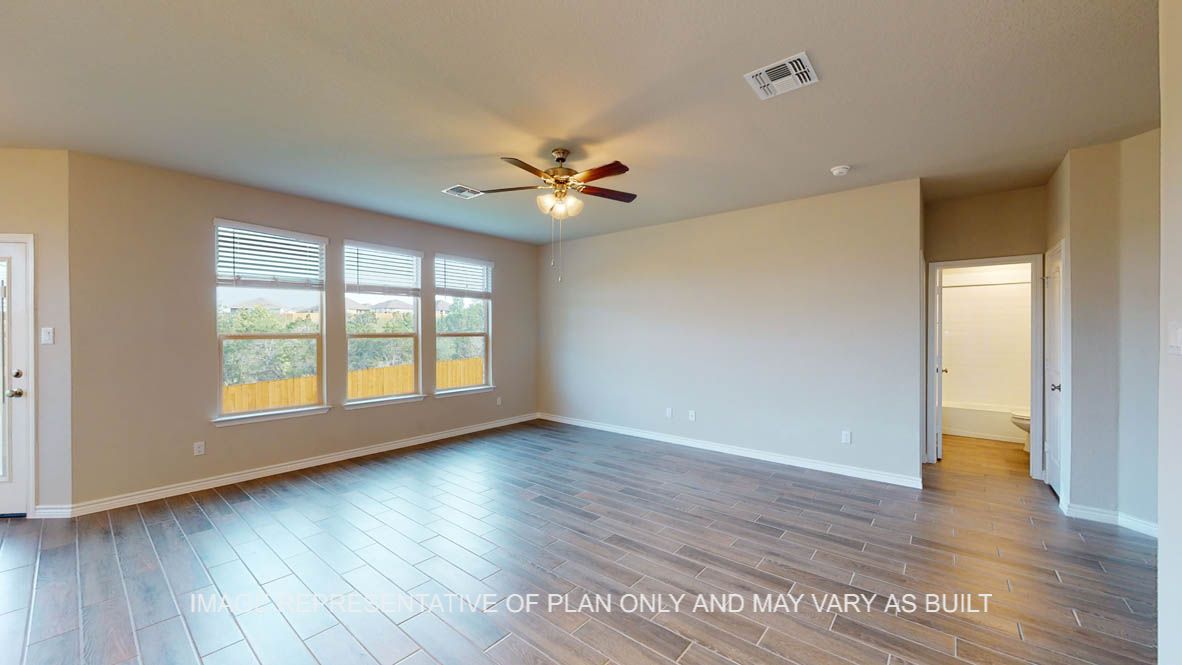 Kiawa living room with vinyl plank flooring throughout and windows.
