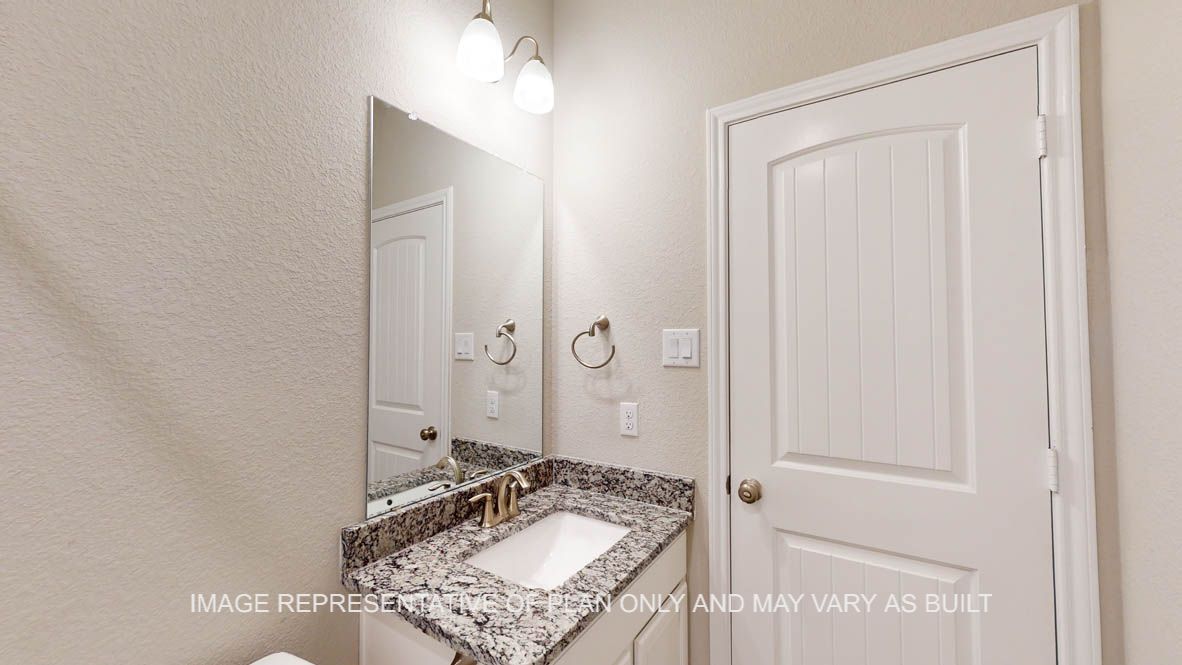 Kiawa secondary bath with single vanity and white cabinets.