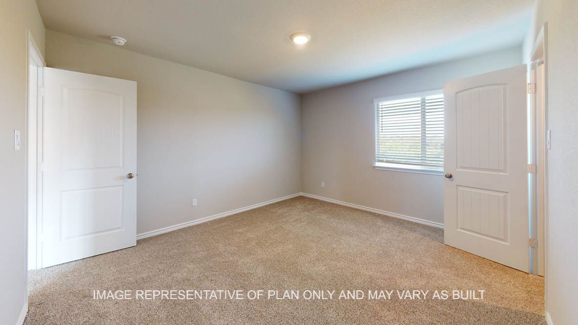 Kiawa secondary bedroom with carpet flooring and window.