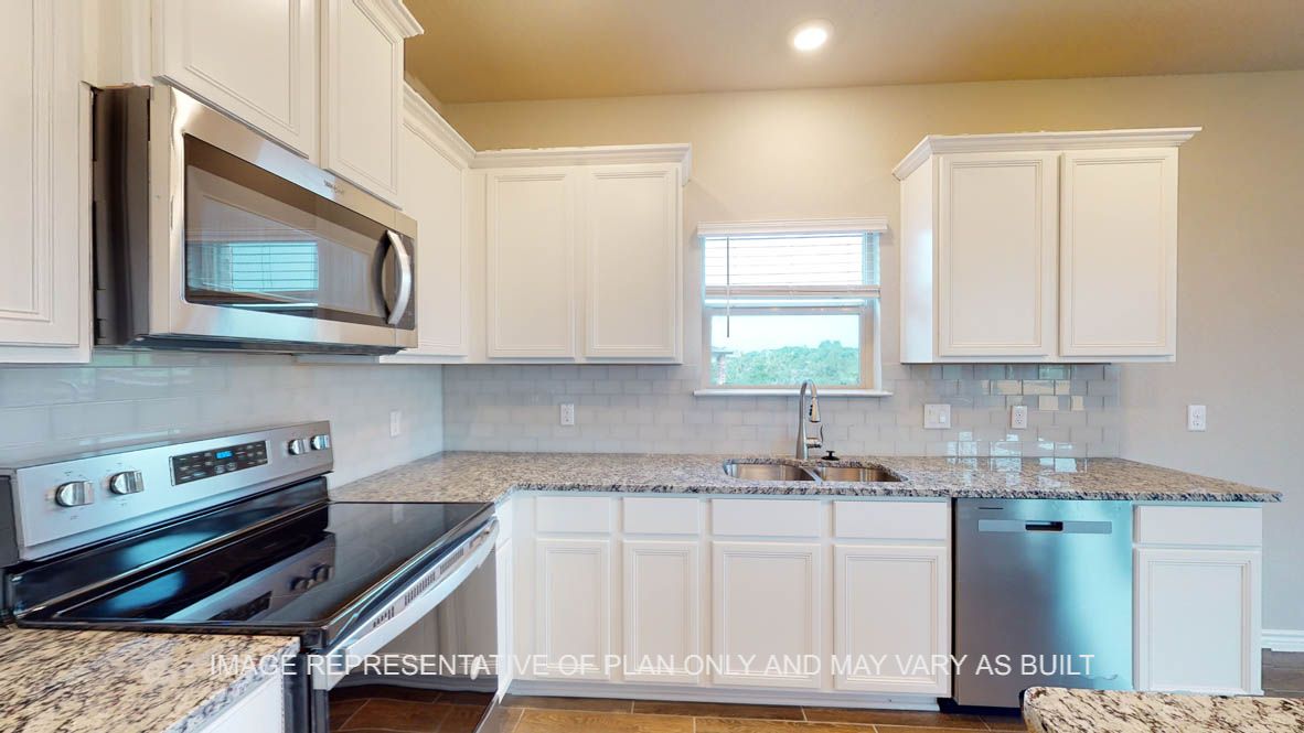 Kiawa kitchen with granite countertops and window above the kitchen sink.