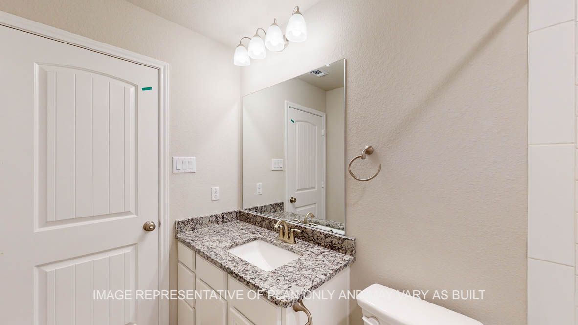 Kiawa secondary bath with single vanity and white cabinets.