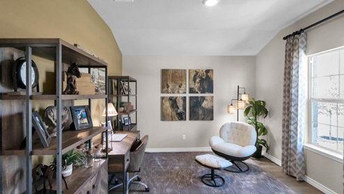 Warrior's Legacy model home secondary bedroom with an office desk and chair.